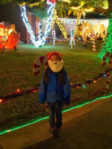 Little Santa enjoying the Christmas lights in the neighborhood at night